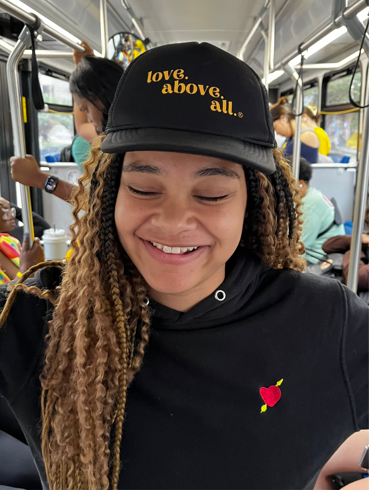 love above all trucker cap