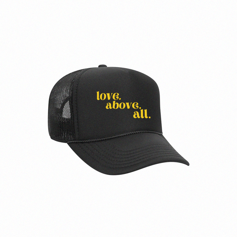 love above all trucker cap